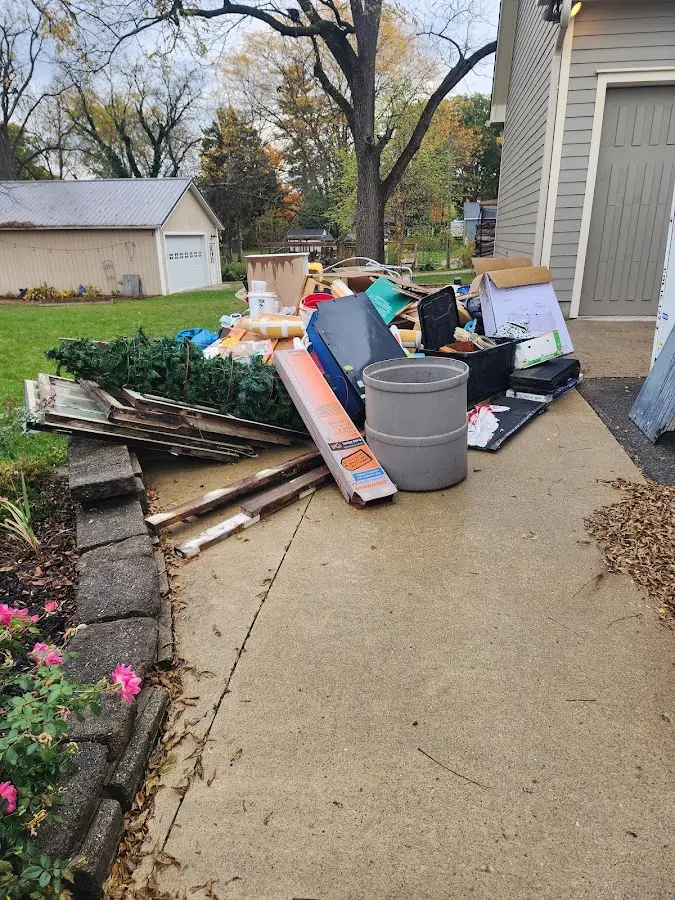 Dumpster being loaded with debris for Estate Cleanout Dumpster Rental in Dakota Ridge
